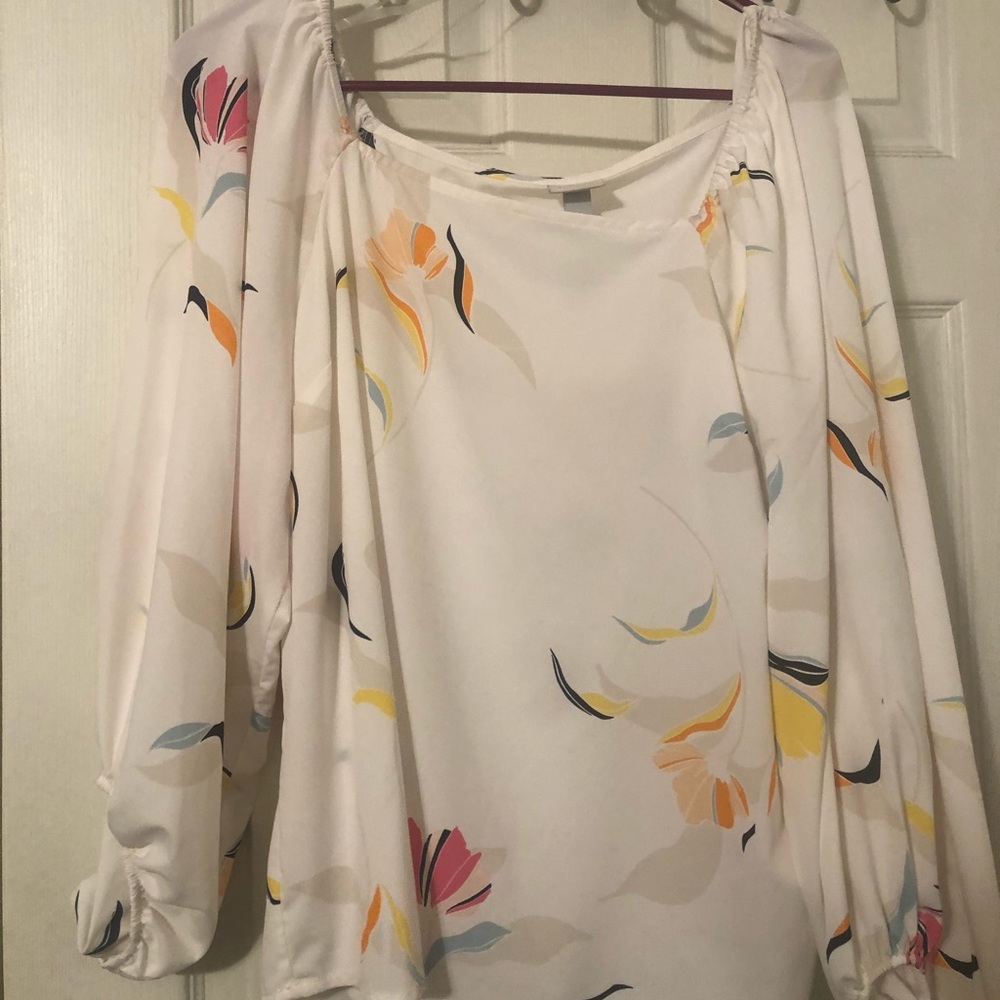 Flowy, white and floral blouse.